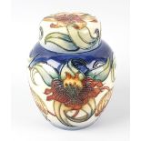 A modern Moorcroft pottery Anna Lily ginger jar and cover, decorated with flowers on a split blue