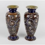 A good pair of Doulton Lambeth stoneware vases by George Tinworth, of ovoid form having foliate