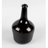 An 18th century green-brown glass utility bottle, the taping body of plain form, 9 (23cm) high. (s/