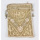 A late 19th century Islamic needlework Koran (Qur'an) cover, with stitched character and floral