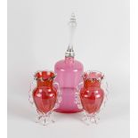 A collection of assorted cranberry glass items, to include a large novelty bell with clear glass