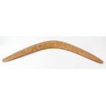 A vintage Australian aboriginal boomerang, of traditional shape and hand carved form, with '