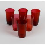 A collection of thirty one cranberry glass beakers and drinking glasses, the beakers of tapered