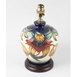 A modern Moorcroft pottery Anna Lily lamp base, of ovoid form with orchids on a split blue and cream