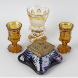 An Art Nouveau brass mounted iridescent glass inkwell, of square form having copper berries to the