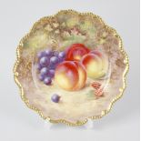 A Royal Worcester hand painted plate, by Harry Ayrton, with peaches and grapes within a lobed and