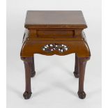 A Chinese carved pine vase stand or occasional table, the moulded rectangular top over recessed