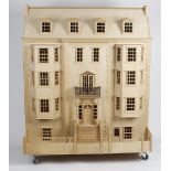 A large and detailed modern doll's house, the tripartite hinged front having turned column and
