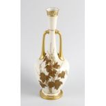 A Royal Worcester blush ivory porcelain vase. Of two-handled form with ovoid body and tall neck,