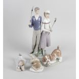 A group of five Lladro figurines, comprising two larger pieces, the first a figure group modelled as