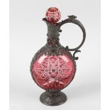 A 19th century pewter mounted cranberry glass decanter, the star-cut circular body within a