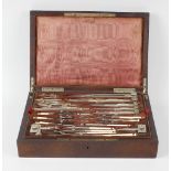 A 19th century rosewood cased technical drawing set, having a vacant cartouche, crown and wreath