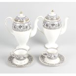 A Wedgwood black and gold Florentine tea service, comprising a three tier cake stand, a square