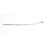 A 19th century 10k gold mounted riding crop, having vermicular terminal with initialled cartouche