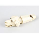 A Victorian ivory whistle, modelled as the head of a dog with open mouth and inset eyes, 3.1, (