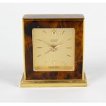 A gilt and simulated tortoiseshell back wound time piece movement with alarm, the gilt dial with