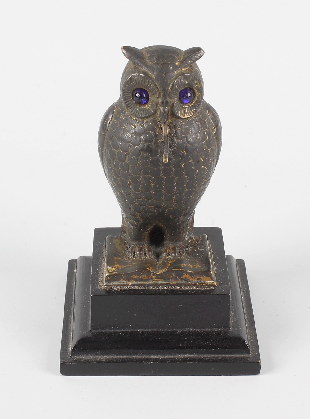 A Victorian bronzed fob watch stand, modelled as an owl with inset blue glass eyes and stood over