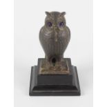 A Victorian bronzed fob watch stand, modelled as an owl with inset blue glass eyes and stood over