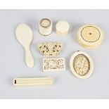 A collection of carved ivory items to include a 19th century circular ivory box and cover with