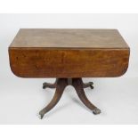 An early 19th century mahogany pedestal Pembroke table. The rectangular top on rounded oblong