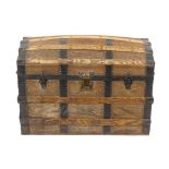 A stained and wooden dome topped trunk with applied leather banding and leather carry handles, a