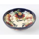 A modern Moorcroft pottery Anna Lily pattern bowl, of circular form with tune-lined flowers on a