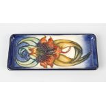 A modern Moorcroft pottery Anna Lily pin tray, of rectangular form with an orchid on a merging