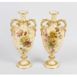 A pair of Royal Worcester porcelain blush ivory vases, of narrow ovoid form having twin scrolled