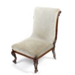 A Victorian rosewood nursing chair, having acanthus carved scrolled back above the square seat,