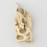 A Japanese Meiji period ivory okimono, modelled as an eagle attacking a snake, 4.5, (11.5cm)