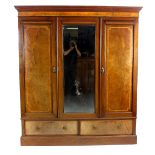 An Edwardian inlaid mahogany triple wardrobe. The central mirrored door flanked by two further