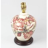 A modern Moorcroft pottery lamp base, of pear form with spray of pink flowers on a cream glaze