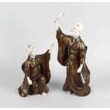 A fine pair of Japanese Meiji period ivory and lacquer figures modelled as geisha or bijin. The