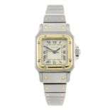 CARTIER - a Santos bracelet watch. Stainless steel case with yellow metal bezel. Numbered