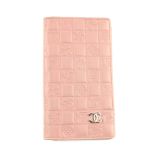 CHANEL - an embossed logo wallet. Featuring a pink lambskin leather exterior, embossed with maker'