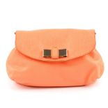 CHLOE - a small bow front handbag. Crafted from neon peach leather, featuring a detachable thin