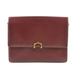 CARTIER - a Bordeaux leather handbag. Featuring maker's signature burgundy leather exterior,
