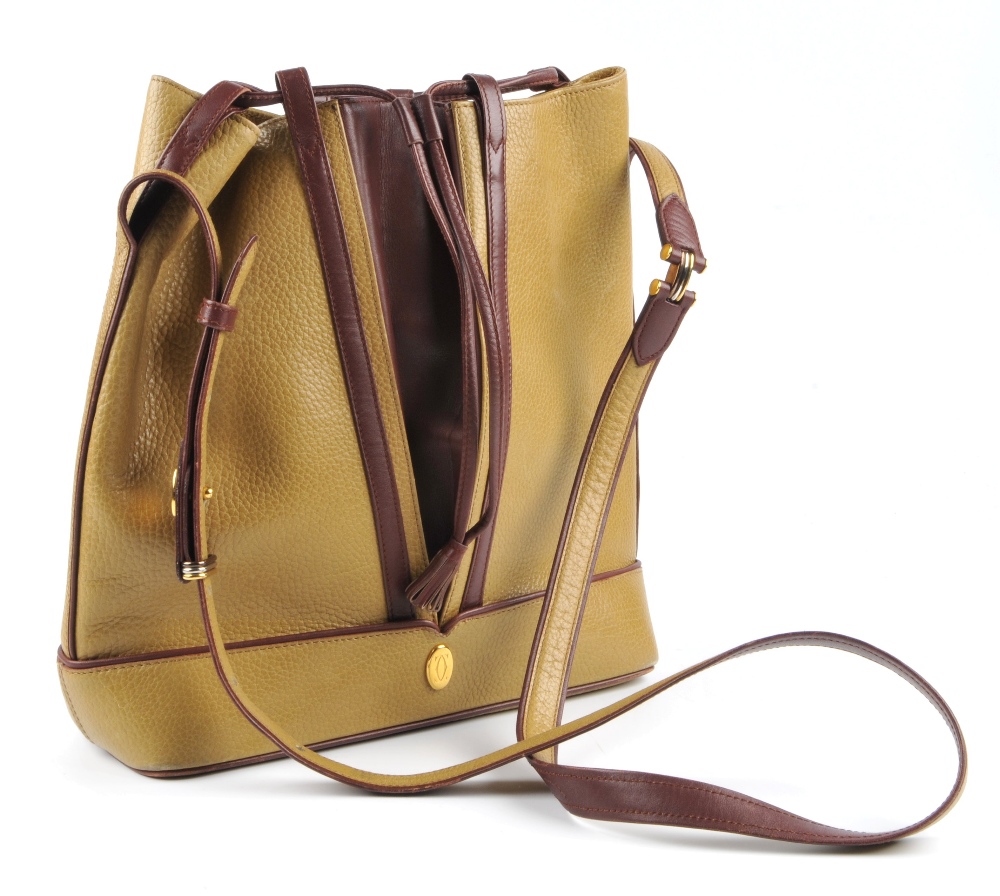 CARTIER - a two-tone bucket tote handbag. Designed with a pebbled mustard leather exterior and - Image 6 of 7
