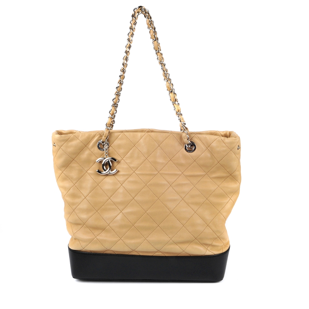 CHANEL - a quilted tote bag. Featuring a beige quilted leather exterior with a smooth black