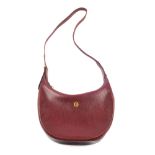 CARTIER - a Bordeaux leather hobo handbag. Featuring a burgundy textured leather exterior with a