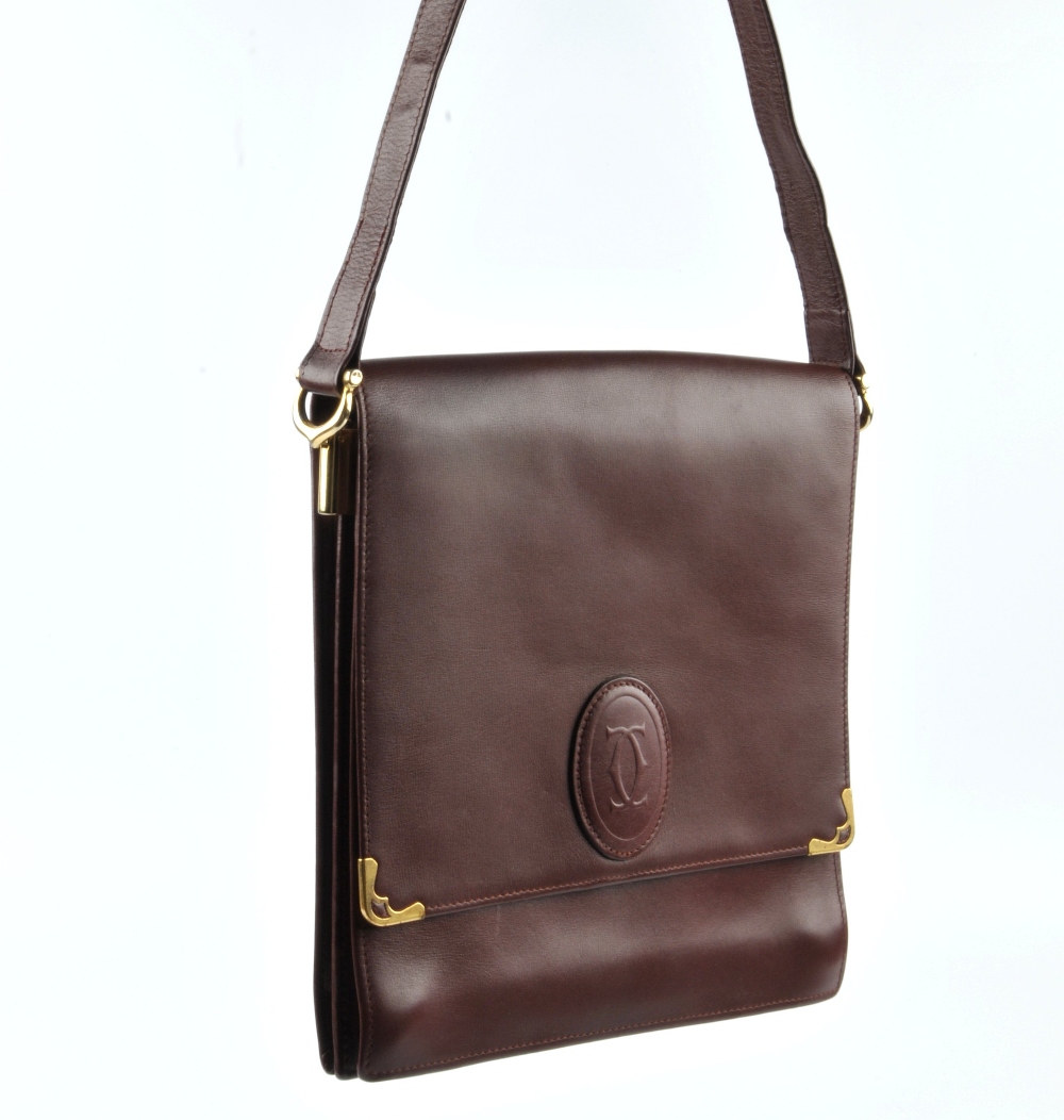 CARTIER - a Bordeaux leather handbag. Featuring a top flap closure with maker's embossed logo emblem - Image 4 of 5