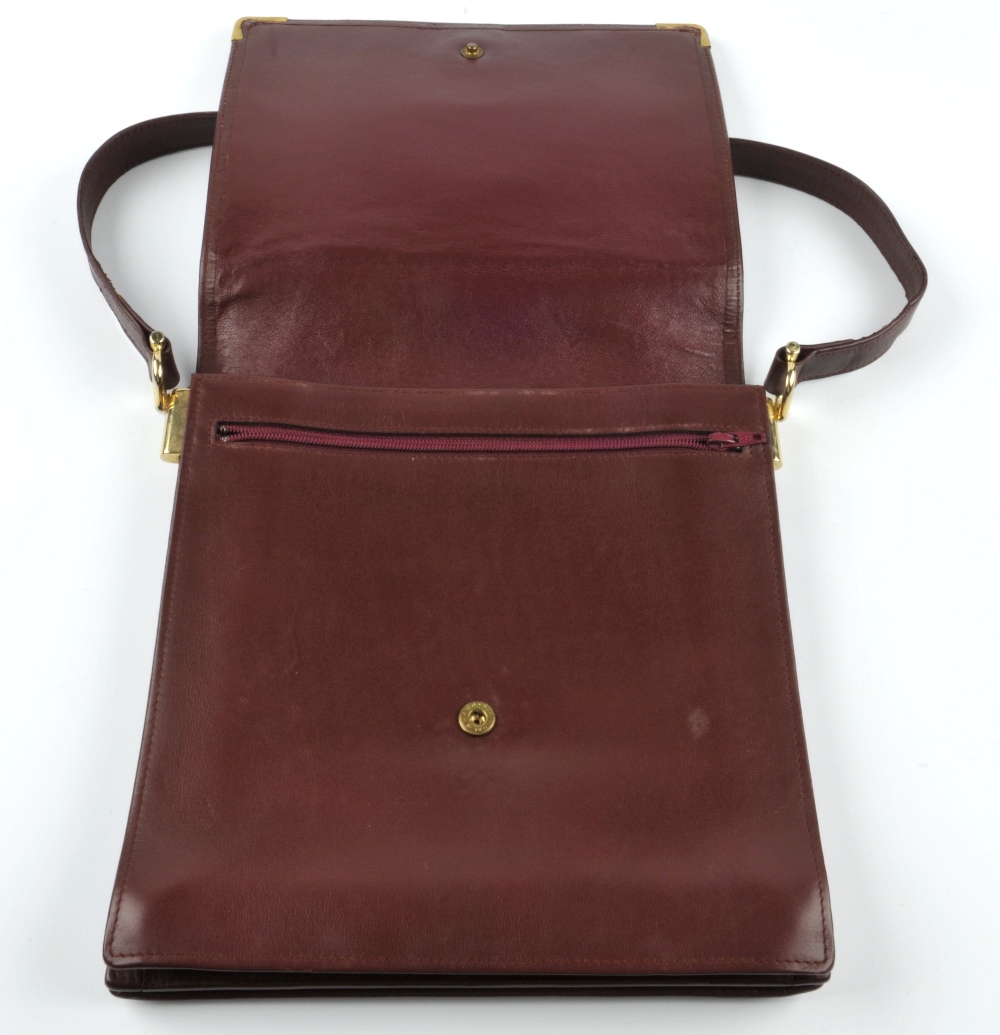 CARTIER - a Bordeaux leather handbag. Featuring a top flap closure with maker's embossed logo emblem - Image 5 of 5