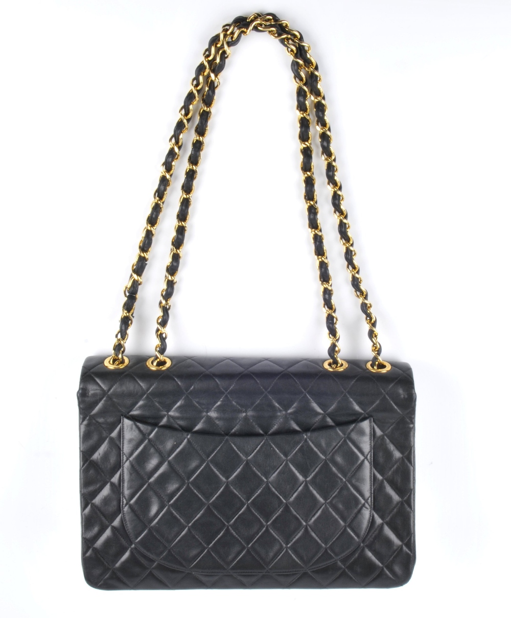 CHANEL - a Maxi Classic Flap handbag. Featuring maker's signature black quilted lambskin leather - Image 2 of 6