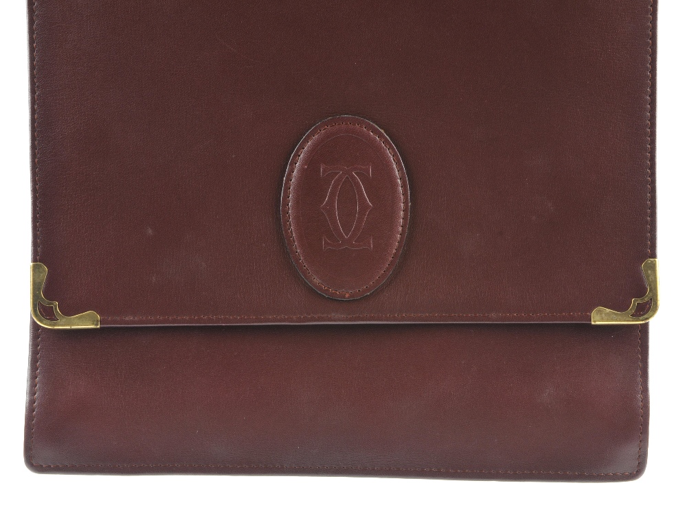 CARTIER - a Bordeaux leather handbag. Featuring a top flap closure with maker's embossed logo emblem - Image 2 of 5
