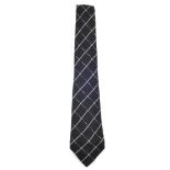 CHANEL - a tie. Of woven black fabric, with cream diamond checked pattern, red logo lining and a