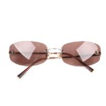 CHANEL - a pair of frameless sunglasses. Designed with brown tinted rimless lenses with maker's CC