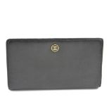 CHANEL - a black wallet. The grained leather exterior with enamel 'CC' to the circular button