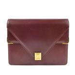 CARTIER - a Bordeaux double flap handbag. Crafted from maker's signature burgundy leather, featuring