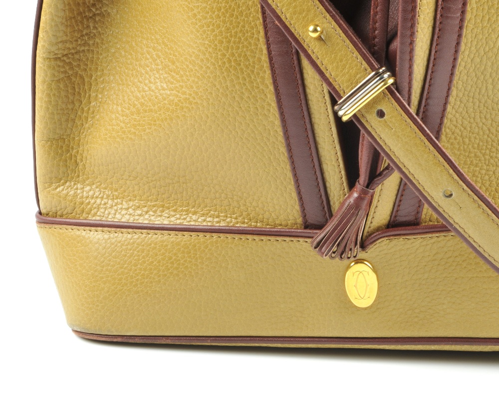 CARTIER - a two-tone bucket tote handbag. Designed with a pebbled mustard leather exterior and - Image 3 of 7