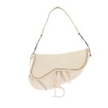 CHRISTIAN DIOR - an ivory leather saddle bag. Featuring a pebbled ivory leather exterior with